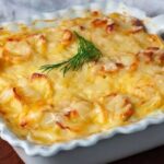 Potatoes au gratin with layers of cream and golden Parmesan