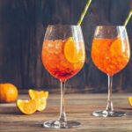 Ramazzotti Spritz cocktail served in a tall wine glass with orange slices and ice.