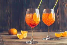 Ramazzotti Spritz cocktail served in a tall wine glass with orange slices and ice.