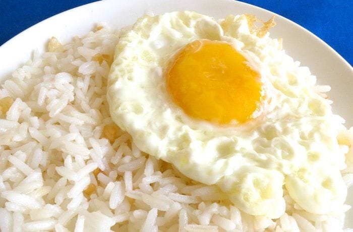 Chilean arroz con huevo, fluffy white rice topped with a runny fried egg and merken