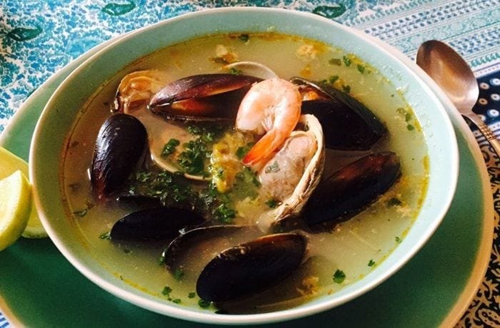 Chilean caldillo de mariscos with clams, mussels, and shrimp in fish broth