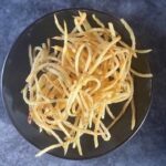 Freshly fried shoestring potatoes, crispy, sprinkled with sea salt and merken, ready to serve.