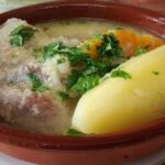Chilean pork and luche seaweed cazuela with potatoes and rice in a deep bowl
