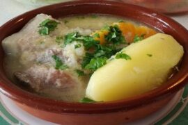 Chilean pork and luche seaweed cazuela with potatoes and rice in a deep bowl