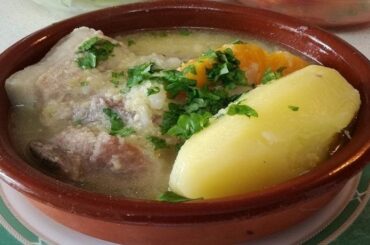 Chilean pork and luche seaweed cazuela with potatoes and rice in a deep bowl