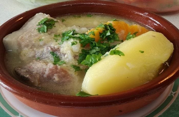 Chilean pork and luche seaweed cazuela with potatoes and rice in a deep bowl