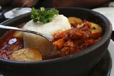 Chilean spicy limpets, served on a plate with steamed white rice.