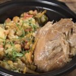 Chilean picante de conejo on a plate with boiled potatoes and cilantro