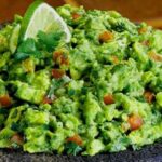 Chilean-style homemade guacamole with tomato, onion, and cilantro