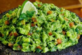 Chilean-style homemade guacamole with tomato, onion, and cilantro