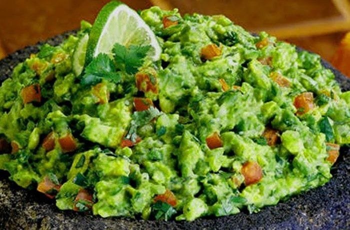 Chilean-style homemade guacamole with tomato, onion, and cilantro
