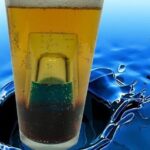 Chilean submarino cocktail, a mint liqueur shot glass sunk inside a tall glass of cold Pilsner beer.