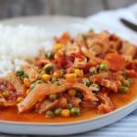 Chilean guatitas a la jardinera, a traditional tripe and vegetable stew, served with fries and rice.