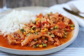 Chilean guatitas a la jardinera, a traditional tripe and vegetable stew, served with fries and rice.