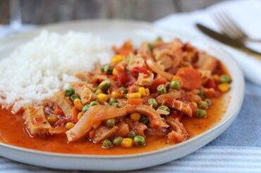 Chilean guatitas a la jardinera, a traditional tripe and vegetable stew, served with fries and rice.