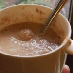 A glass of Chilean ulpo, a toasted flour and milk drink, dusted with a pinch of cinnamon.
