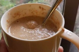 A glass of Chilean ulpo, a toasted flour and milk drink, dusted with a pinch of cinnamon.