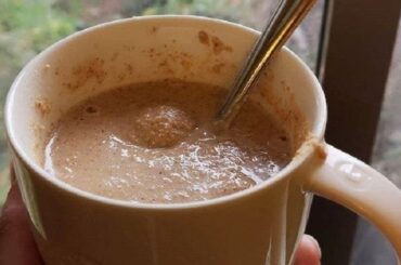 A glass of Chilean ulpo, a toasted flour and milk drink, dusted with a pinch of cinnamon.