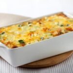 A gratinated Chilean zucchini loaf with melted golden cheese on top, ready to serve.