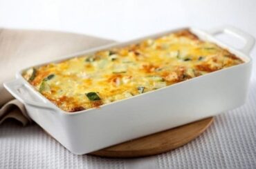 A gratinated Chilean zucchini loaf with melted golden cheese on top, ready to serve.