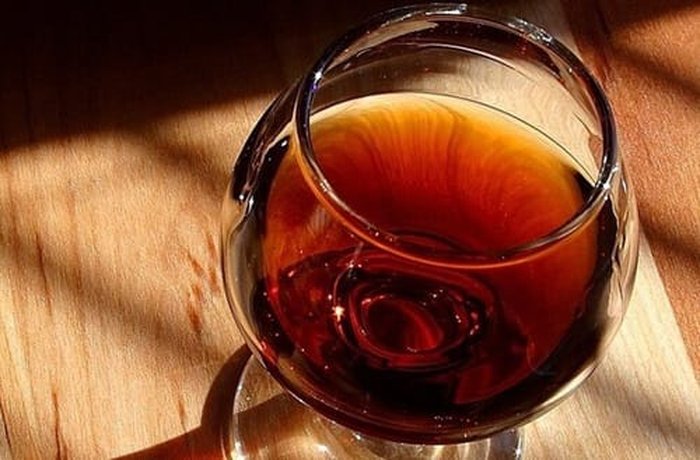 Cognac or brandy used for flambeing and building the chicken sauce.