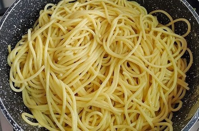 Cooked drained noodles ready to toss with the changles