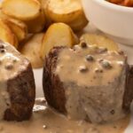 Creamy morel mushroom sauce served over a cut of meat