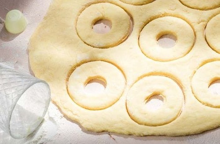 Donut rings cut and proofing on a tray