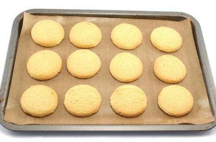Cut vanilla cookies on a baking tray ready to bake