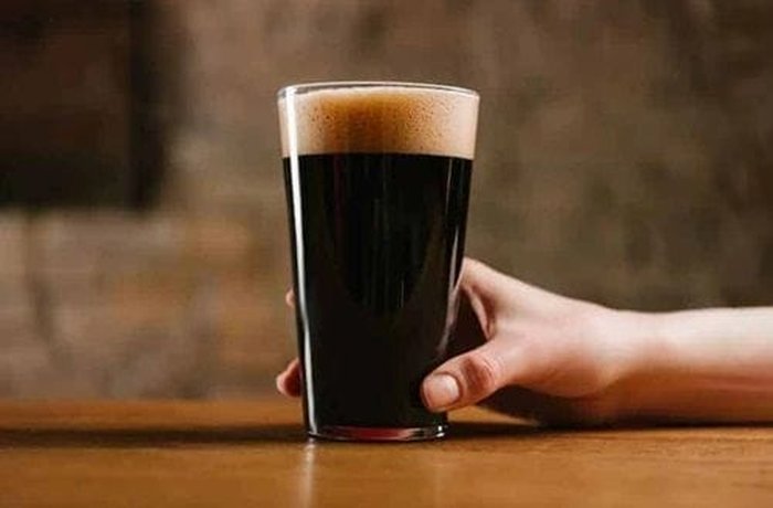 Dark beer poured over the short ribs for braising