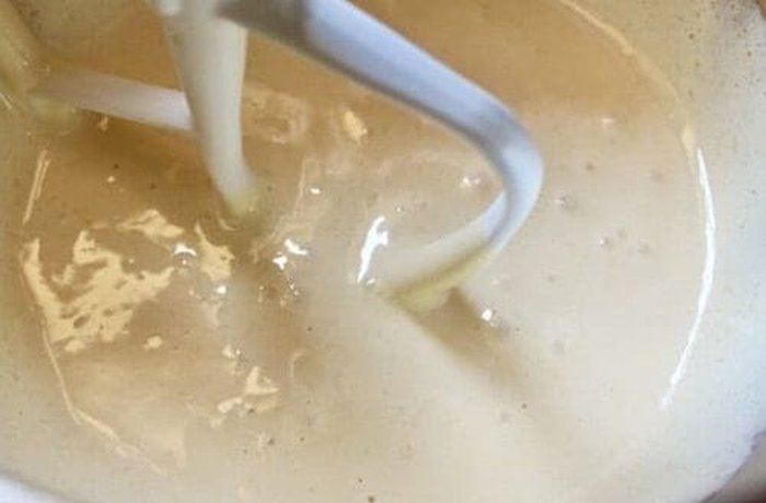 Smooth cream of butter, sugar, and egg yolks being whipped for the cake base