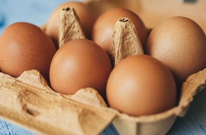 Two fresh eggs in a bowl, ready to be whisked.