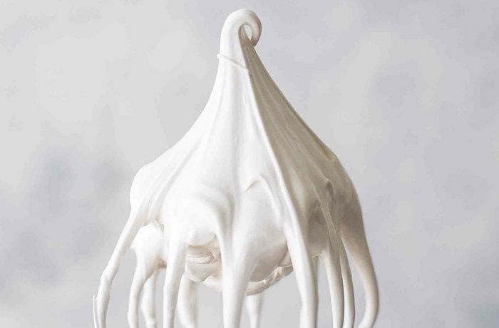 Freshly whipped meringue White, creamy meringue, freshly whipped in a bowl and ready to mix with the syrup.