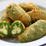 Golden, crispy fried cheese-stuffed jalapeños with dipping sauce