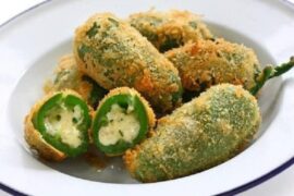 Golden, crispy fried cheese-stuffed jalapeños with dipping sauce