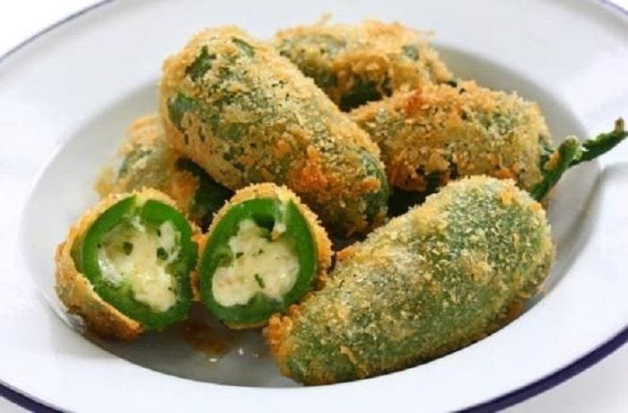 Golden, crispy fried cheese-stuffed jalapeños with dipping sauce