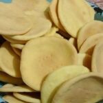 Gluten-free hojarascas baked and stacked, ready to be filled with manjar for alfajores.