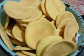Gluten-free hojarascas baked and stacked, ready to be filled with manjar for alfajores.