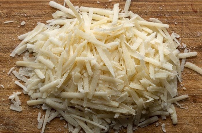 Grated parmesan cheese, used to top the papas champi.