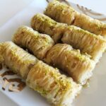 Homemade baklava rolls drizzled with honey