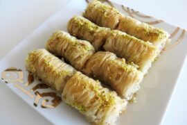 Homemade baklava rolls drizzled with honey