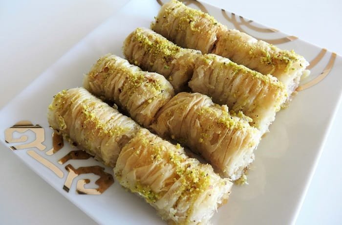 Homemade baklava rolls drizzled with honey