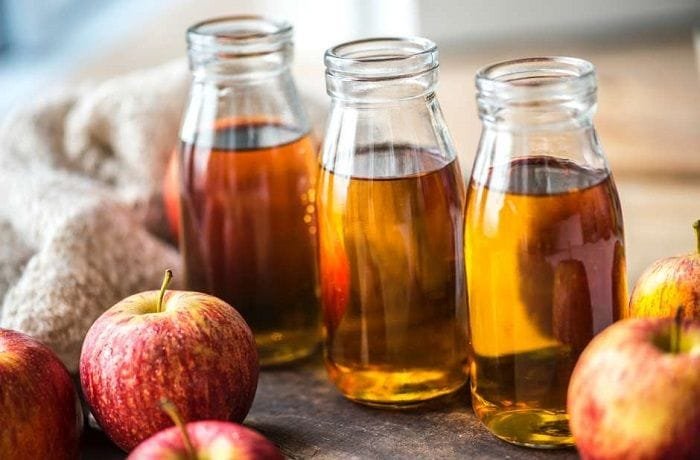 Homemade Chilean apple cider vinegar in glass bottles