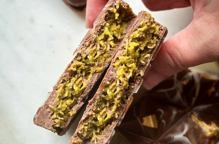 Homemade Dubai chocolate bar broken open to show the green pistachio and kataifi filling