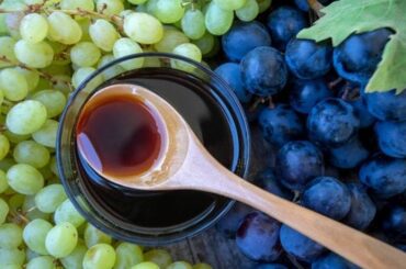 Homemade grape honey, a cooked grape must syrup, in a glass jar