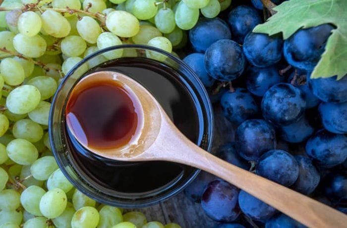 Homemade grape honey, a cooked grape must syrup, in a glass jar