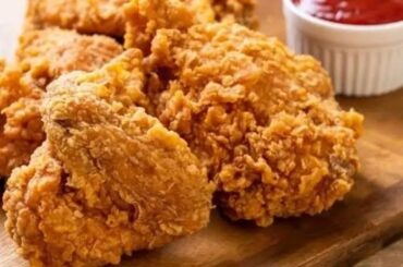 Homemade KFC-style crispy fried chicken pieces with a thick, craggy crust