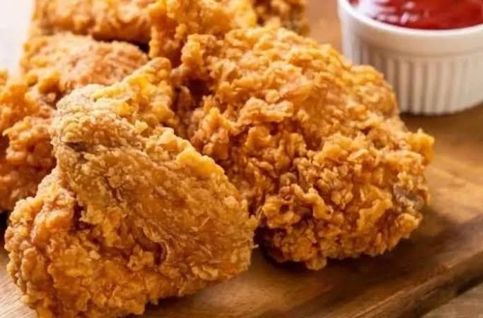 Homemade KFC-style crispy fried chicken pieces with a thick, craggy crust