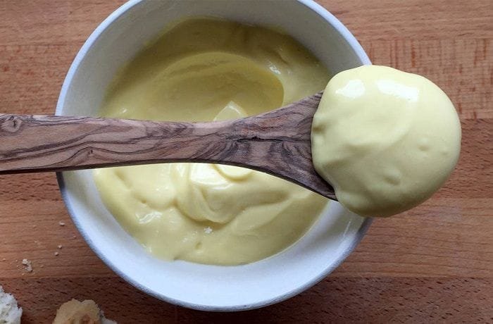 Homemade mayonnaise in a bowl, the base for the scallion and crab sauce.