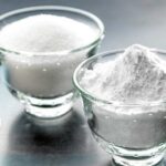 White homemade powdered sugar dusted over a dark surface